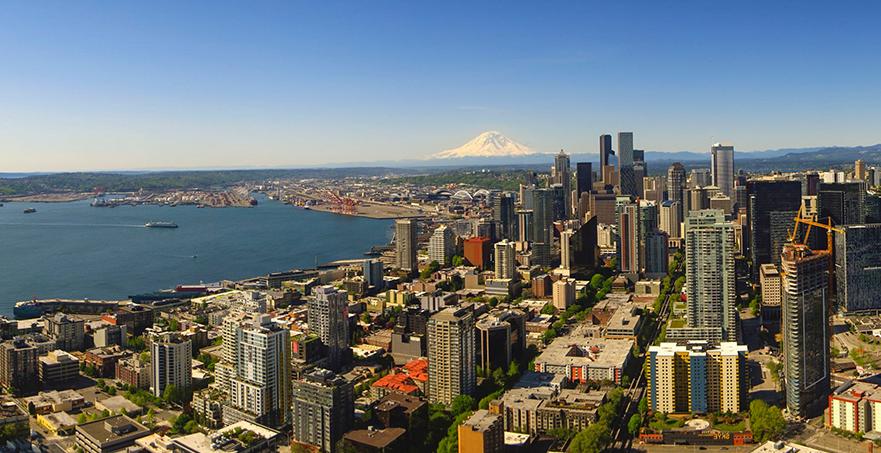 Downtown Seattle with waterfront and view of Mount Rainier